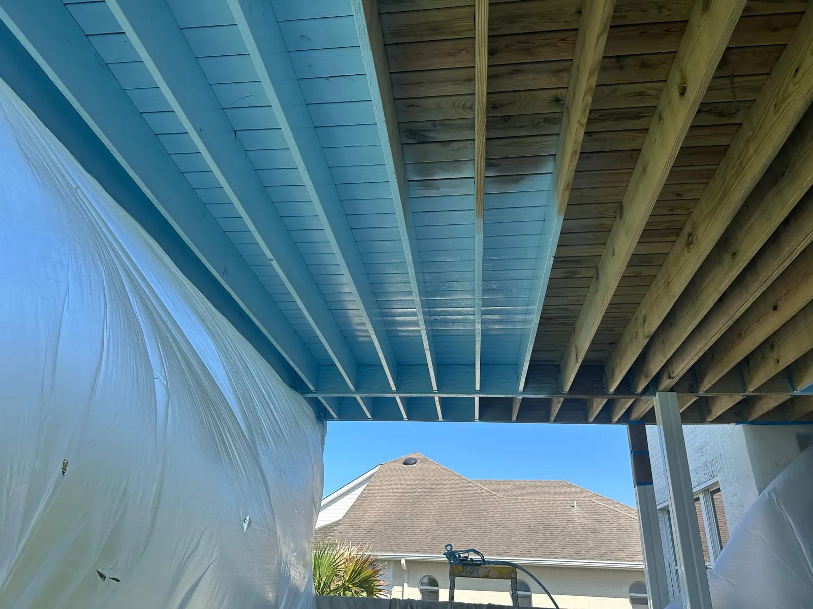 Under-deck painting process and finishing in Oak Island, NC - elevated deck underside painting